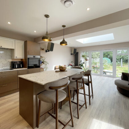 Light-filled open-plan kitchen, dining and living space with rooflight and garden views following a home renovation in Whitstable.